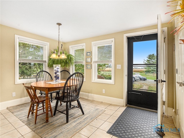 dining room featuring a notable chandelier and light tile patterned floors