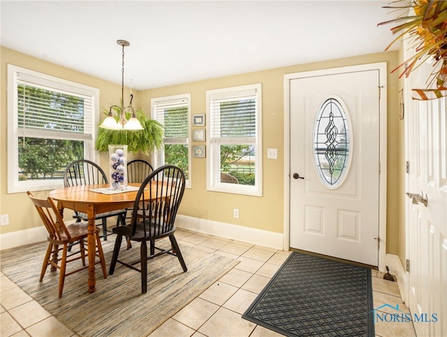 dining room featuring an inviting chandelier, a wealth of natural light, and light tile patterned floors