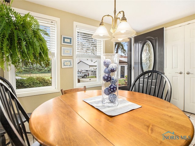 dining area featuring a notable chandelier