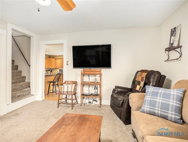 living room featuring light carpet and ceiling fan