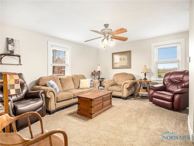 carpeted living room featuring ceiling fan