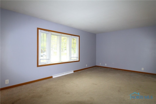 empty room with a baseboard radiator and carpet flooring