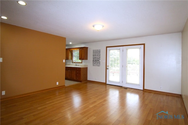 unfurnished room featuring sink and light wood-type flooring