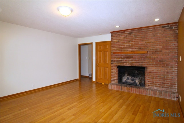 unfurnished living room with a fireplace and hardwood / wood-style floors