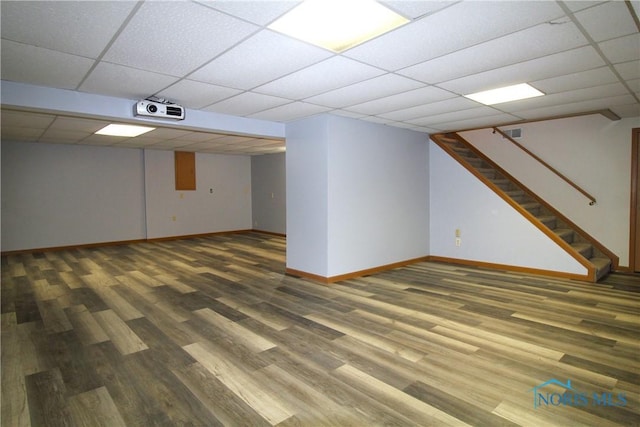 basement featuring hardwood / wood-style flooring and a paneled ceiling