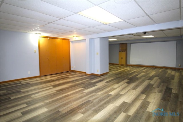 basement featuring wood-type flooring and a drop ceiling