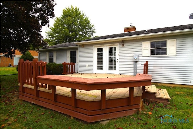 wooden deck featuring a lawn