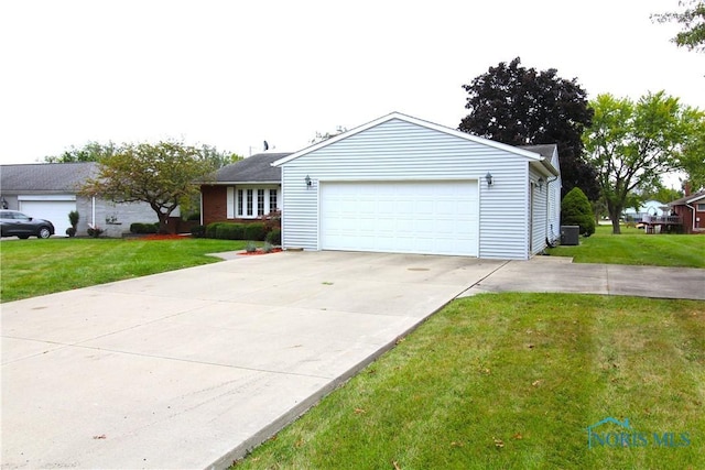 single story home with a garage and a front lawn