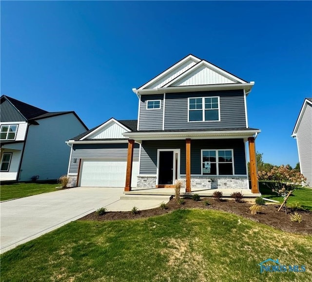 craftsman inspired home with a porch, a garage, and a front lawn