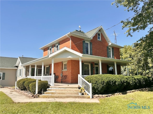 view of front of home with a porch and a front lawn