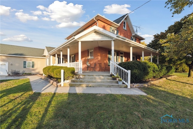 farmhouse featuring a porch and a front lawn