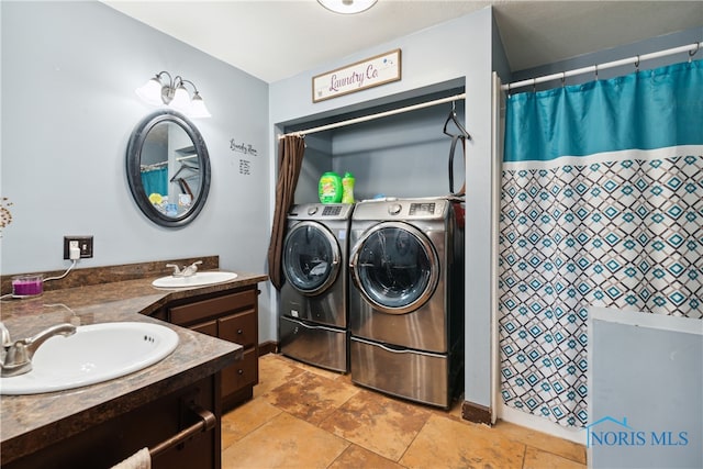 bathroom with vanity and washer and dryer