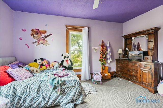 carpeted bedroom featuring a textured ceiling and ceiling fan