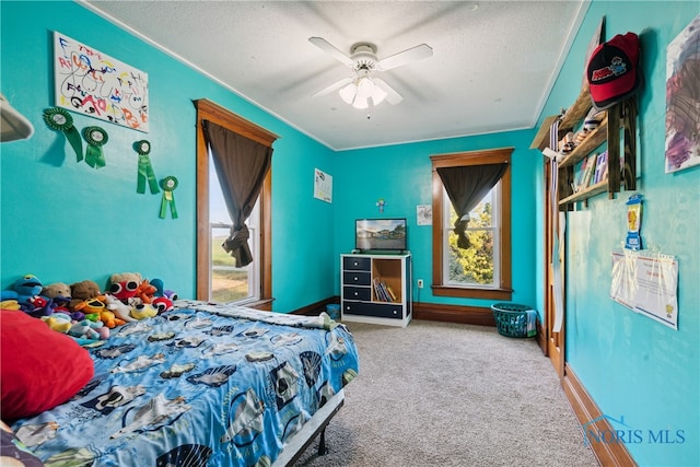 carpeted bedroom featuring a textured ceiling and ceiling fan