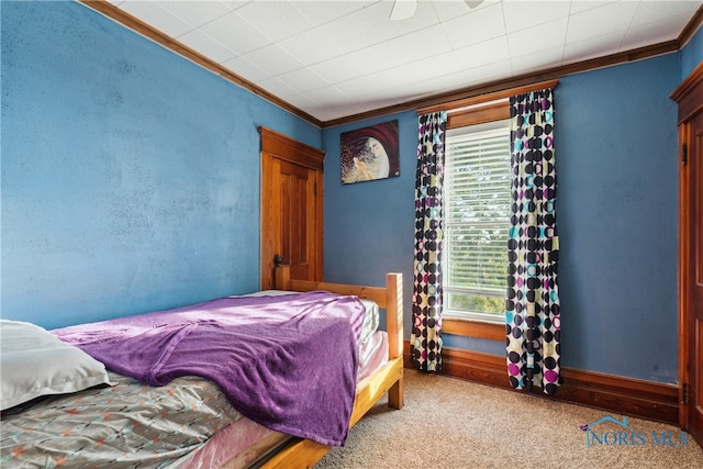 carpeted bedroom featuring multiple windows and ornamental molding