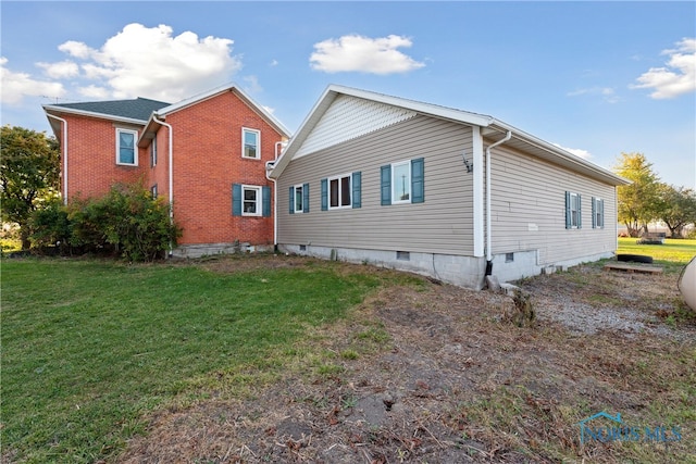 view of property exterior with a lawn