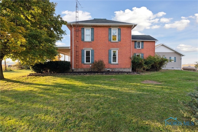 back of house featuring a yard