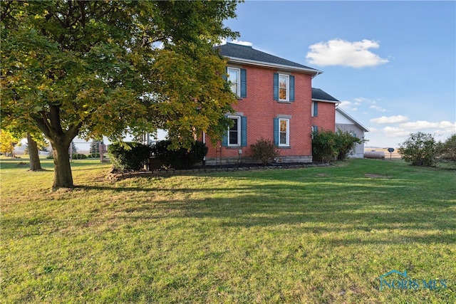 view of side of property with a yard