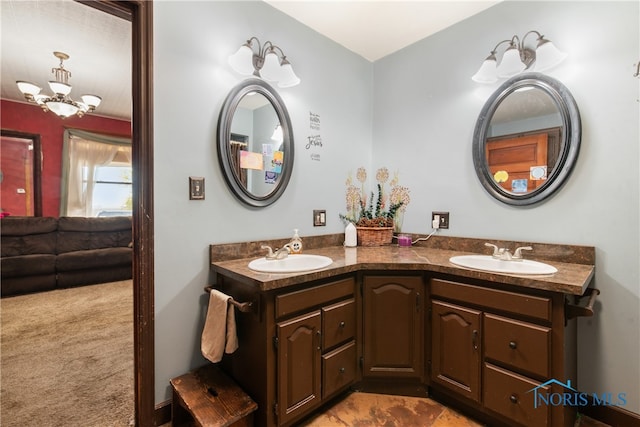 bathroom with vanity and an inviting chandelier