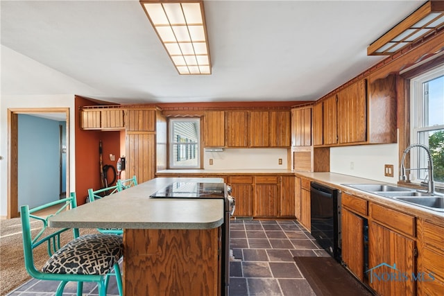 kitchen with a breakfast bar area, sink, dishwasher, and plenty of natural light