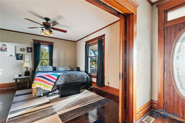 bedroom featuring crown molding, ceiling fan, and dark hardwood / wood-style flooring