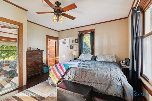 bedroom featuring dark hardwood / wood-style flooring, crown molding, and ceiling fan