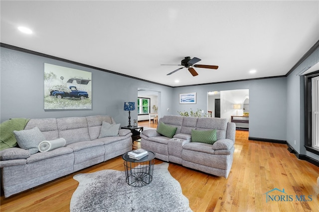 living room with ceiling fan, light hardwood / wood-style flooring, and crown molding