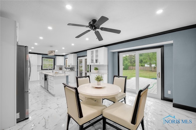 dining space featuring ornamental molding and ceiling fan