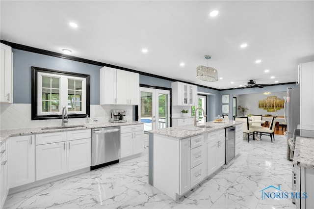 kitchen featuring white cabinets, sink, and stainless steel dishwasher