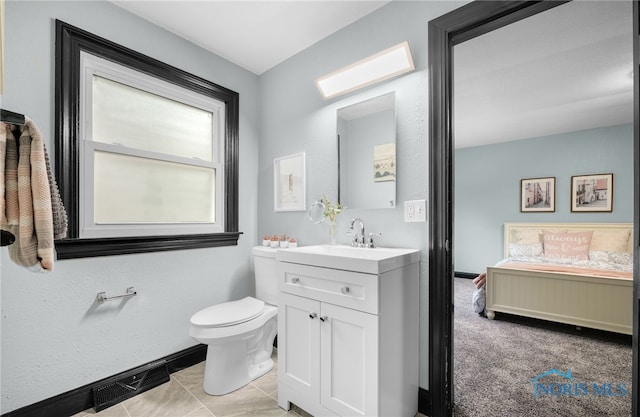 bathroom featuring vanity, toilet, and tile patterned floors