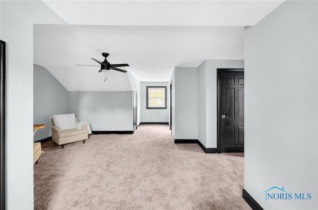 unfurnished room with vaulted ceiling, ceiling fan, and light colored carpet