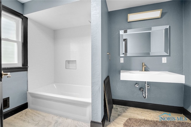 bathroom featuring shower / washtub combination, sink, and hardwood / wood-style flooring