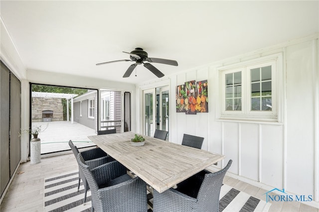 sunroom / solarium featuring ceiling fan