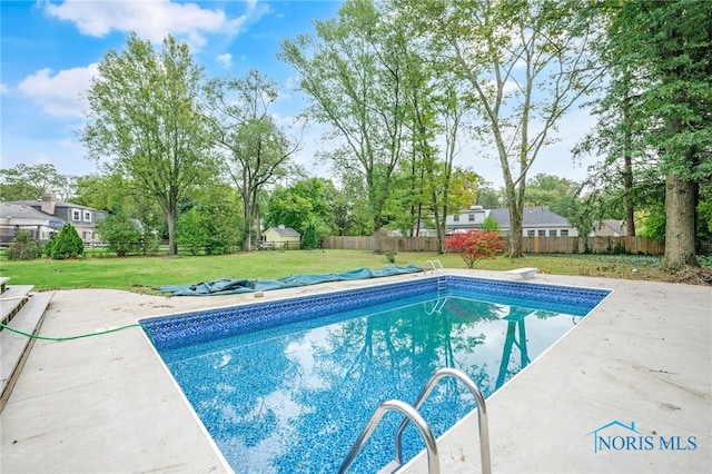 view of pool featuring a yard and a patio