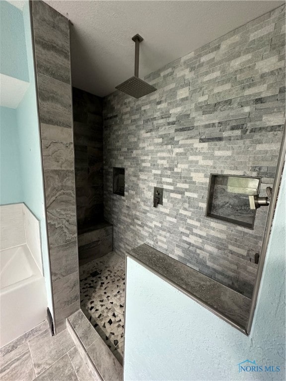 bathroom with walk in shower and tile patterned floors