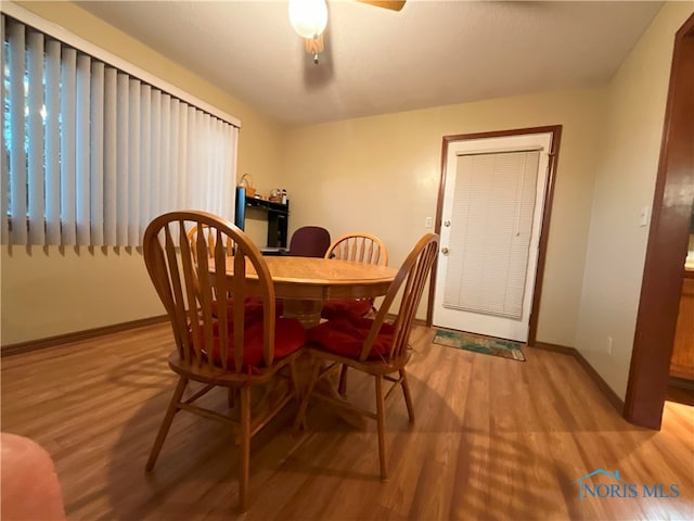 dining area featuring light wood-type flooring and ceiling fan