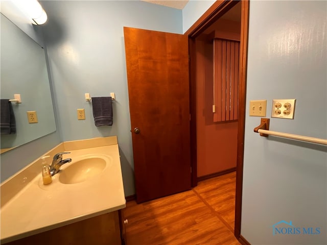 bathroom featuring vanity and hardwood / wood-style flooring