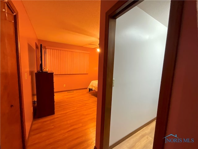 hallway with light hardwood / wood-style floors