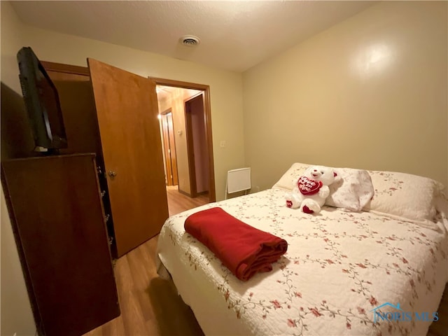 bedroom featuring wood-type flooring