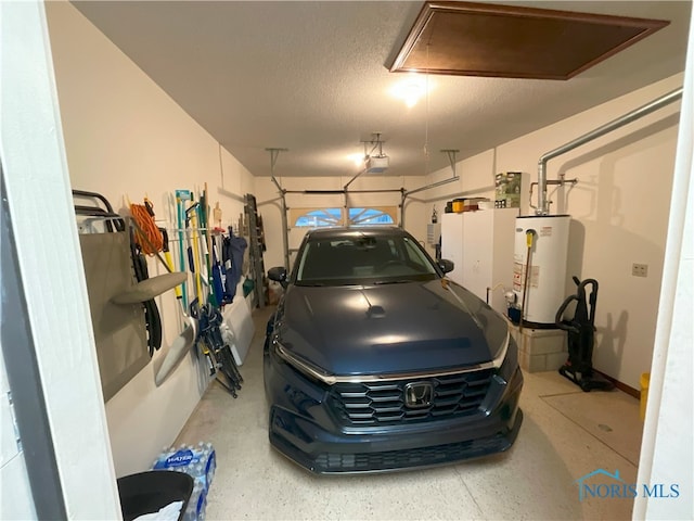 garage featuring a garage door opener and water heater