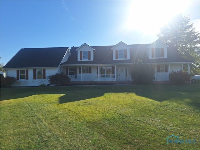 cape cod-style house featuring a front lawn and covered porch