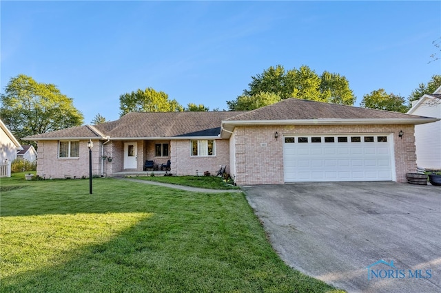 ranch-style home with a front lawn and a garage