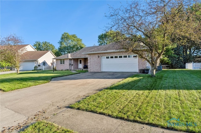 ranch-style home with a front yard and a garage