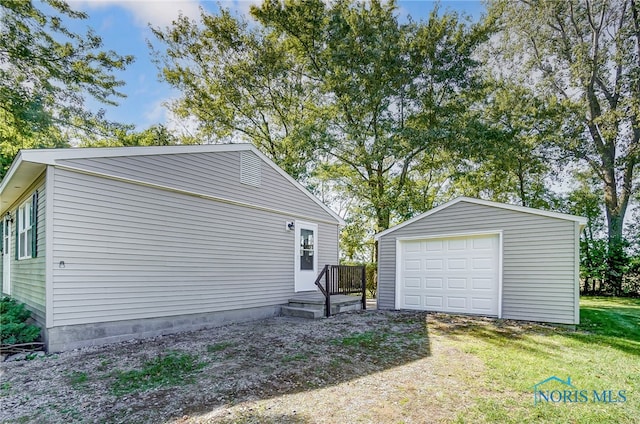 view of home's exterior featuring an outbuilding, a yard, and a garage