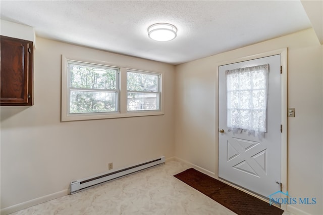 doorway to outside with a baseboard heating unit, a textured ceiling, and plenty of natural light