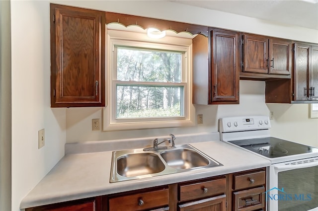 kitchen with white range with electric cooktop and sink