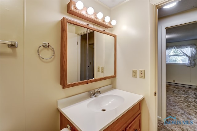 bathroom with a baseboard heating unit and vanity