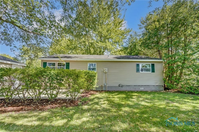 rear view of property with a lawn