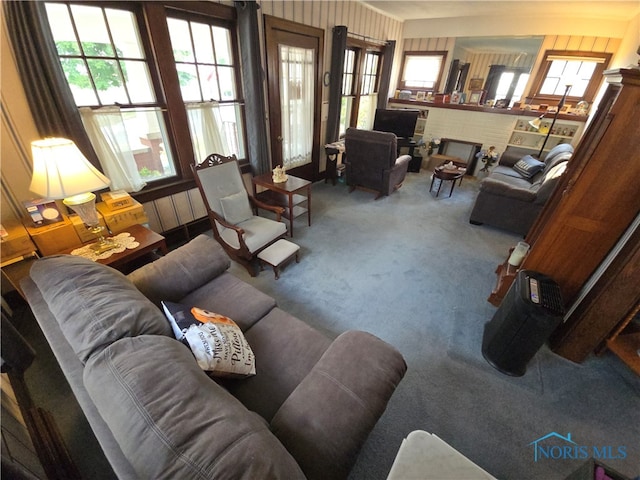 carpeted living room with a fireplace