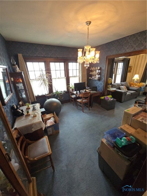 living room featuring a notable chandelier and carpet